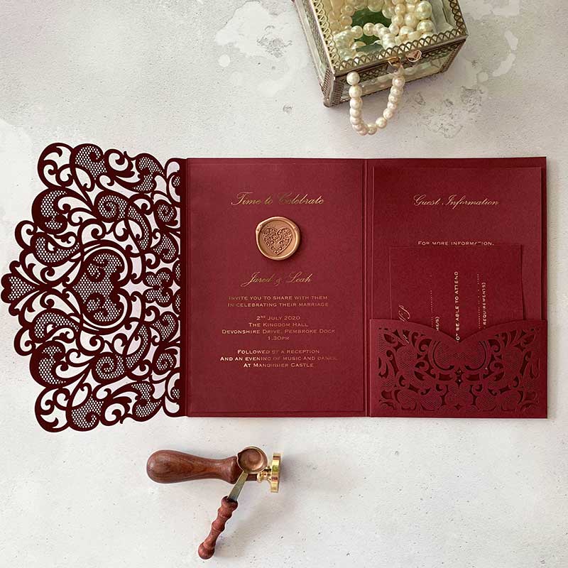 Warm Gold wax seal on Amelie laser cut wedding invitation in wine color