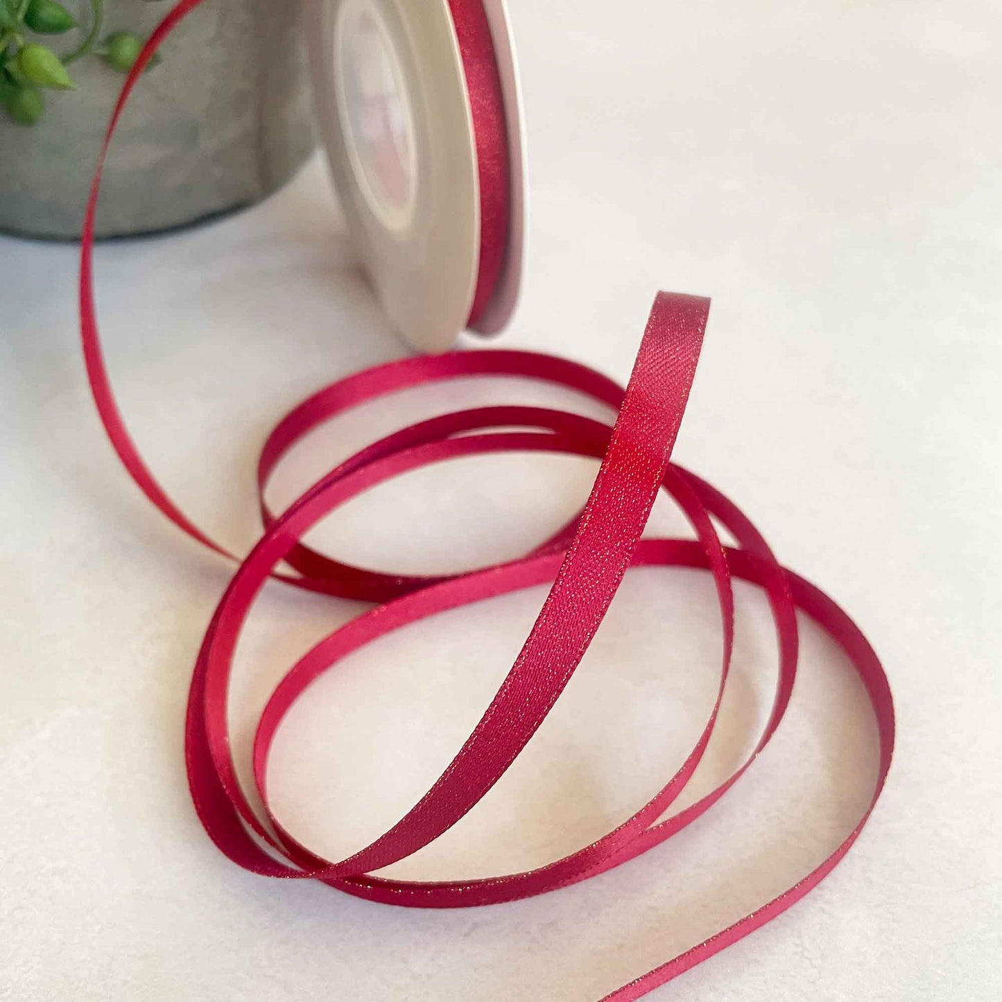 narrow red ribbon with gold sparkle