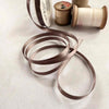 narrow satin ribbon in a minky brown colour.  6mm wide.  Sold on a roll or by the metre