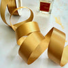 1 inch wide satin ribbon in gold.  Perfect for decorating wedding invitations and stationery
