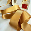 38mm wide satin ribbon in gold.  