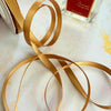 Thin gold satin ribbon.  6mm satin ribbon sold by the meter or on a roll