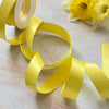 19mm wide satin ribbon in lemon yellow.  Sold in 10 metre rolls or in 1 metre lengths