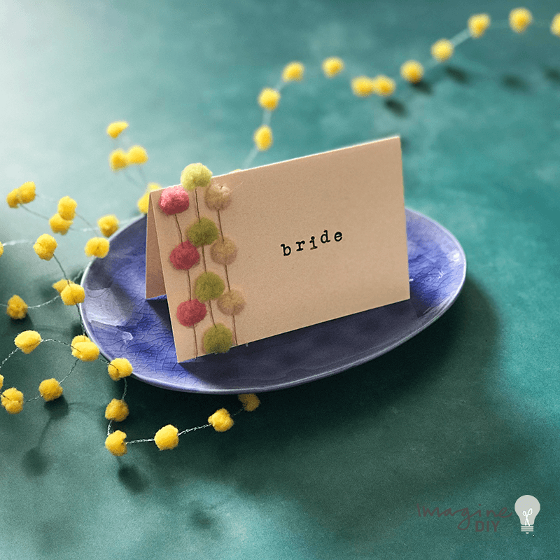 DIY_wedding_place_card_with_pom_poms.png