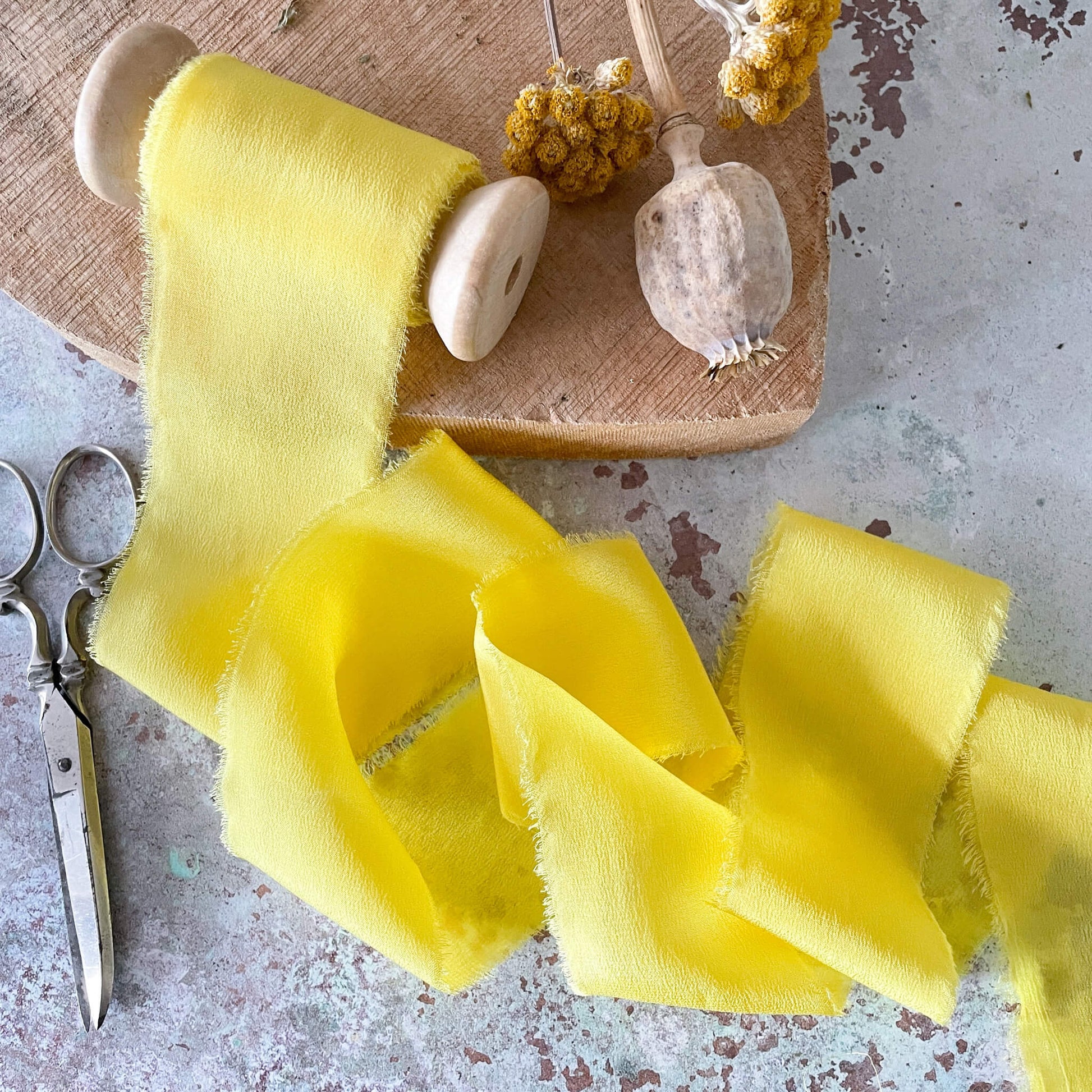 yellow-silk-ribbon-on-wooden-spool