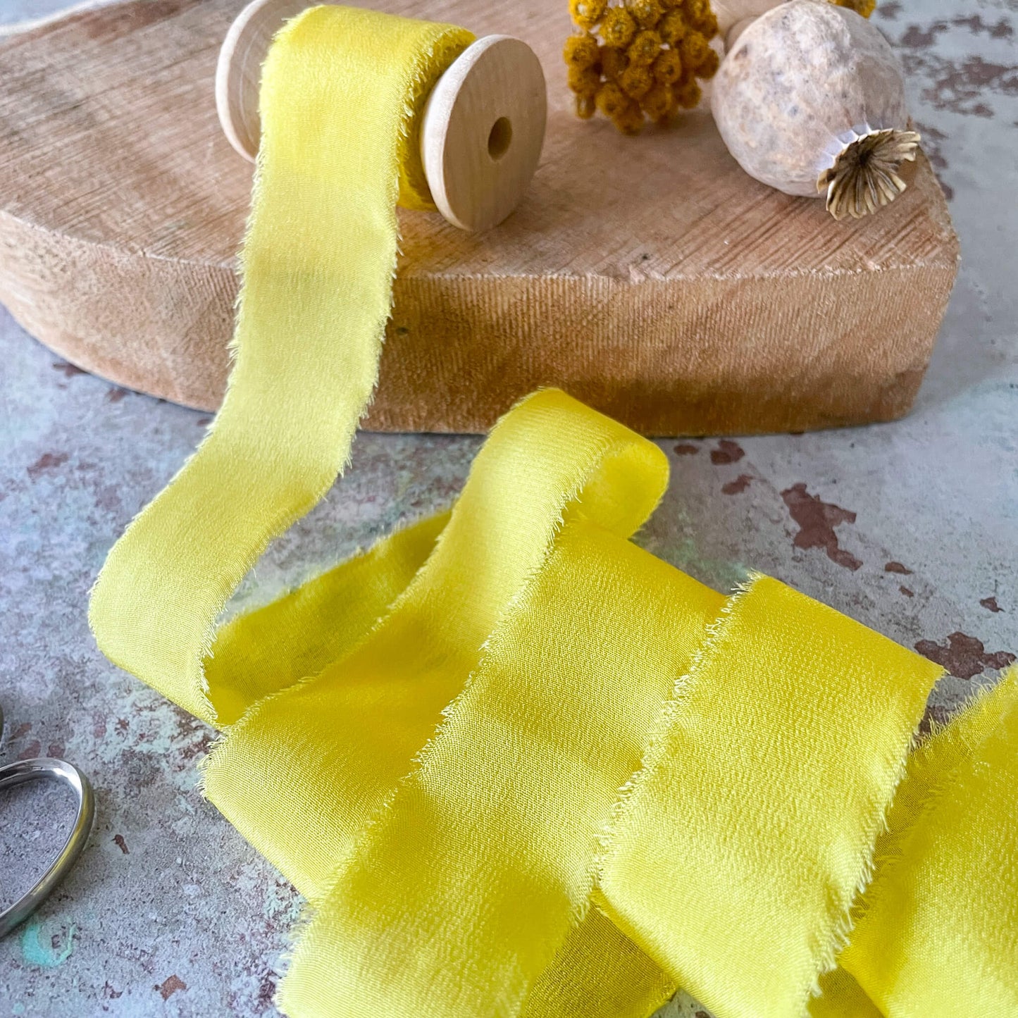 yellow-silk-ribbon-on-wooden-reel