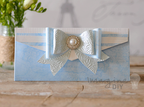blue_and_white_diy_wedding_invitation_with_pearl_embellishment_and_bow