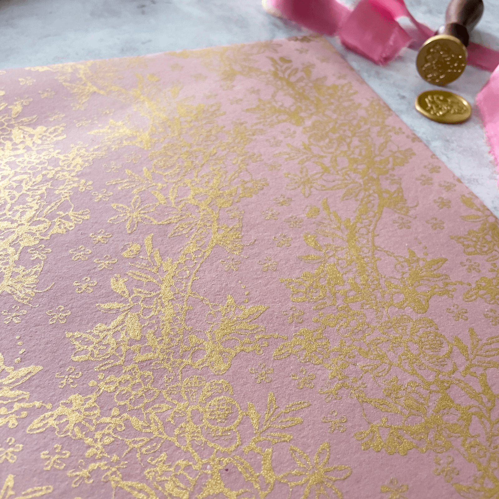 pink-recycled-paper-with-gold-floral-pattern