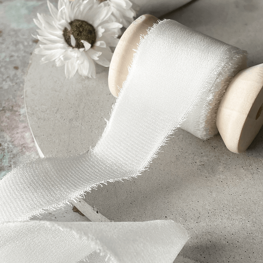 white-silk-ribbon-on-wooden-spool